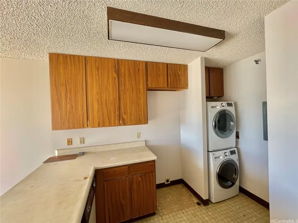 a utility room with sink dryer and washer