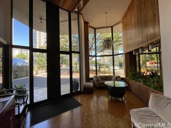 a living room with furniture and a floor to ceiling window