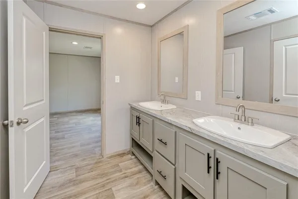 a bathroom with a double vanity sink and a mirror