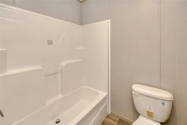 a bathroom with a toilet and bathtub