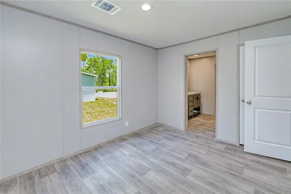 an empty room with windows and closet