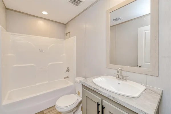 a bathroom with a sink toilet tub and shower