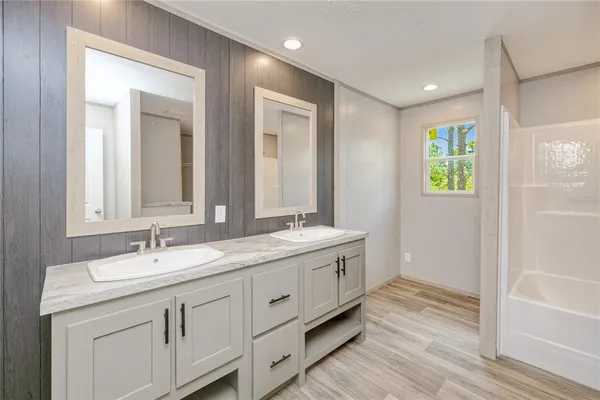 a bathroom with 2 sink tub and a mirror