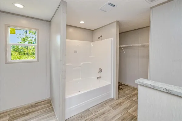 a bathroom with a bathtub and a shower