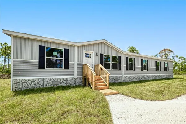 a front view of a house with swimming pool and porch