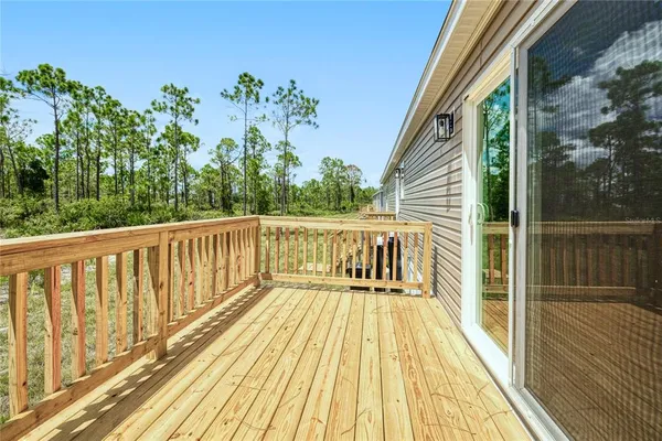 a view of balcony with wooden floor and fence