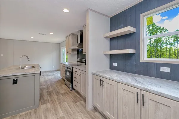 a kitchen with a sink stove and cabinets