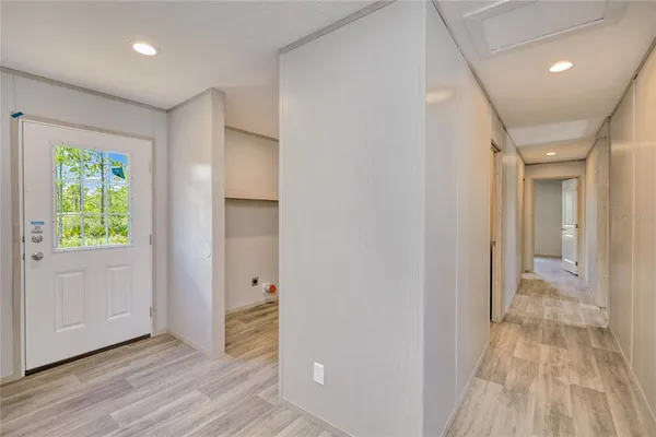 a view of hallway with wooden floor
