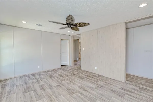 a view of an empty room and wooden floor