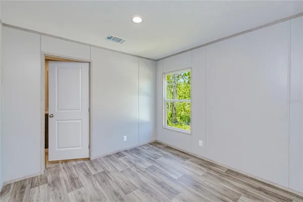 an empty room with windows and entrance