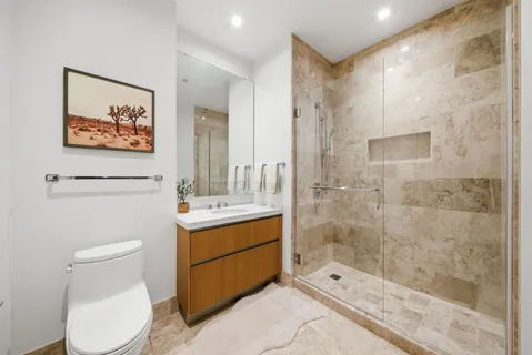 a bathroom with a toilet sink and shower