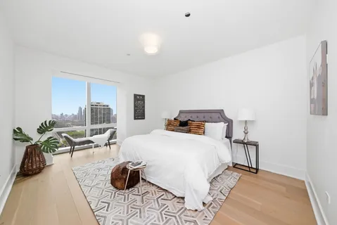 a bedroom with a bed and ceiling fan