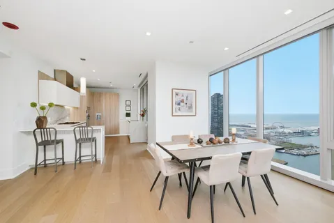 a dining room with furniture window and wooden floor