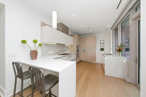 a kitchen with a table chairs refrigerator and microwave