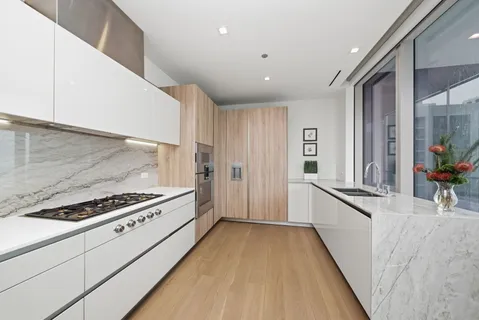a kitchen with stainless steel appliances a refrigerator and a stove top oven