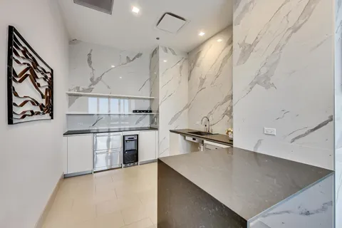 a kitchen with stainless steel appliances cabinets and a window