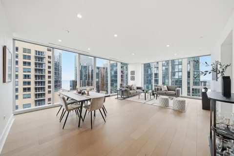 a living room with furniture and large windows