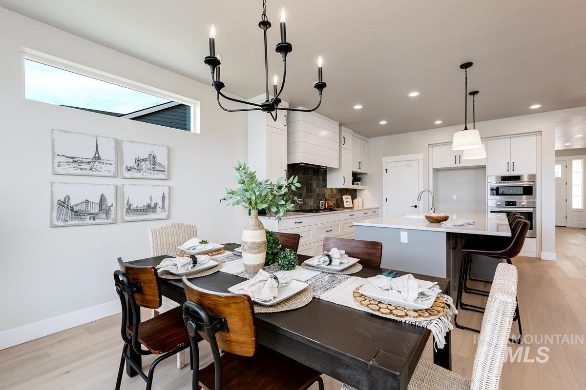 992 East Crescendo Street Meridian, ID 83642 - Photo 15 of 38 Dining area featuring hanging lights and light wood finished floors