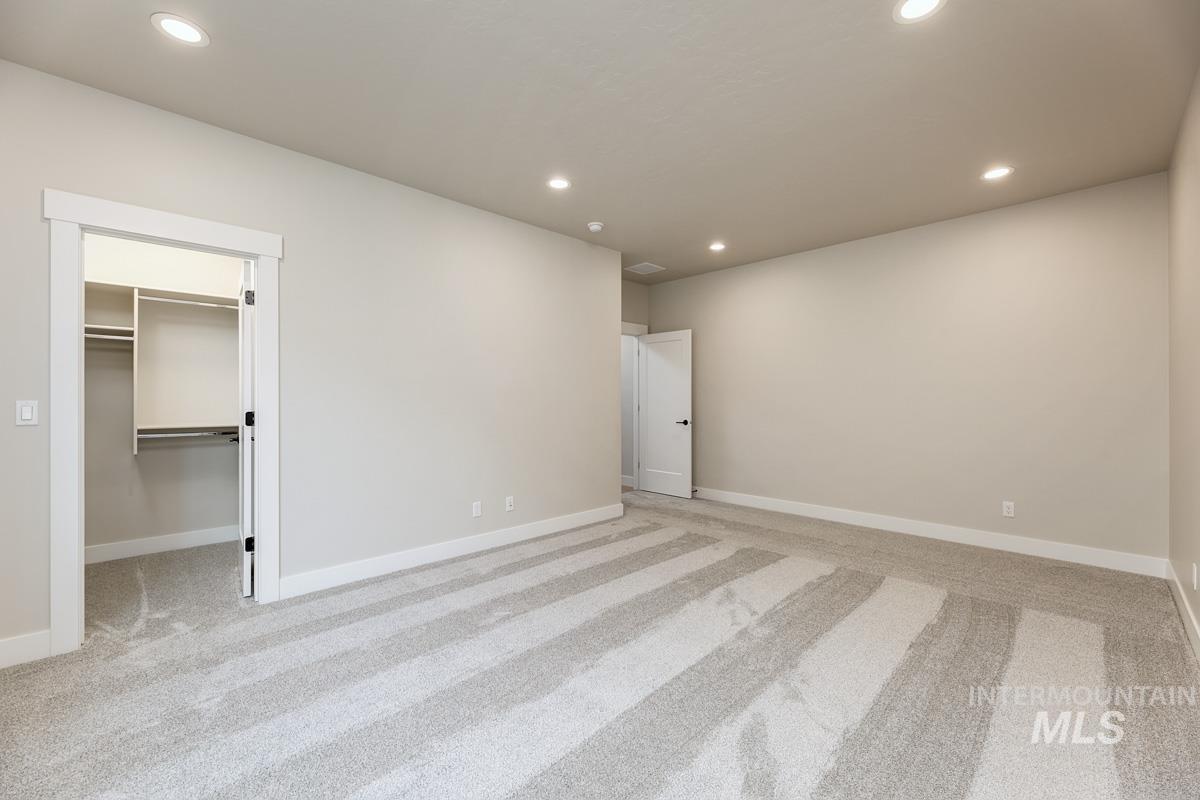 992 East Crescendo Street Meridian, ID 83642 - Photo 20 of 38 Unfurnished bedroom with a spacious closet, light carpet, and recessed lighting