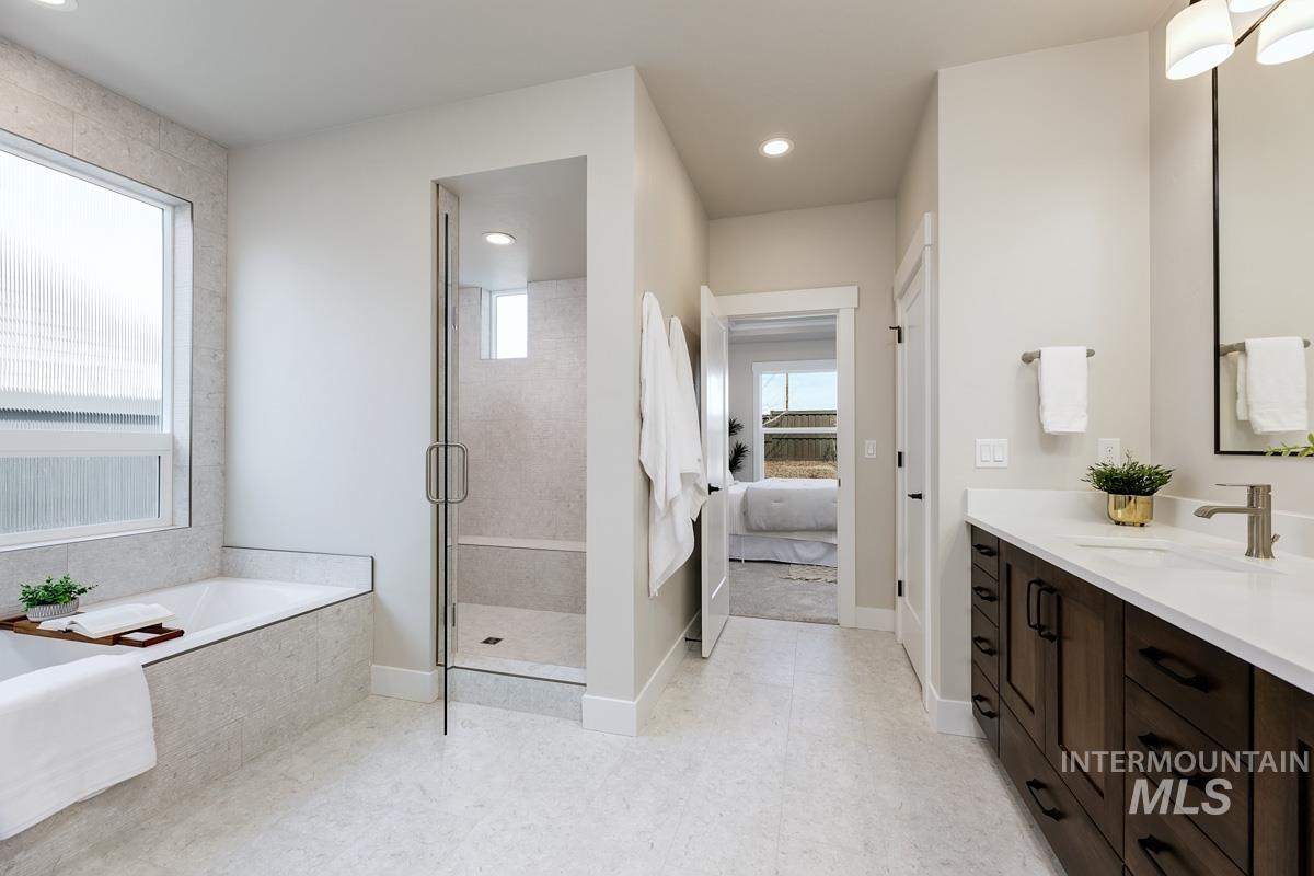 992 East Crescendo Street Meridian, ID 83642 - Photo 24 of 38 Full bath with vanity, a garden tub, connected bathroom, a stall shower, and recessed lighting