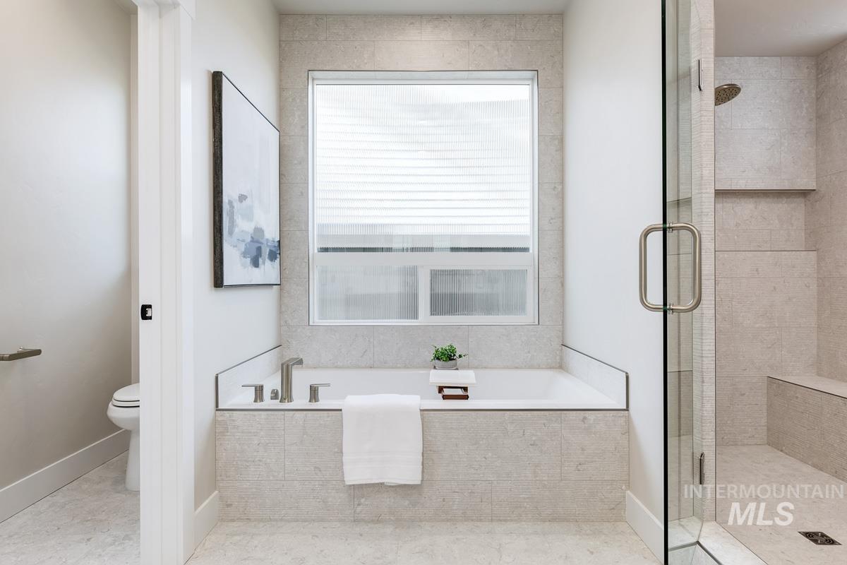 992 East Crescendo Street Meridian, ID 83642 - Photo 25 of 38 Bathroom featuring a bath and a stall shower