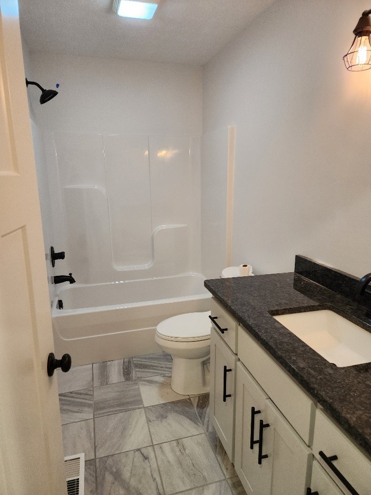 150 Hickory Ridge Lane Hartsville, TN 37074 - Photo 12 of 20 a bathroom with a granite countertop sink toilet and shower