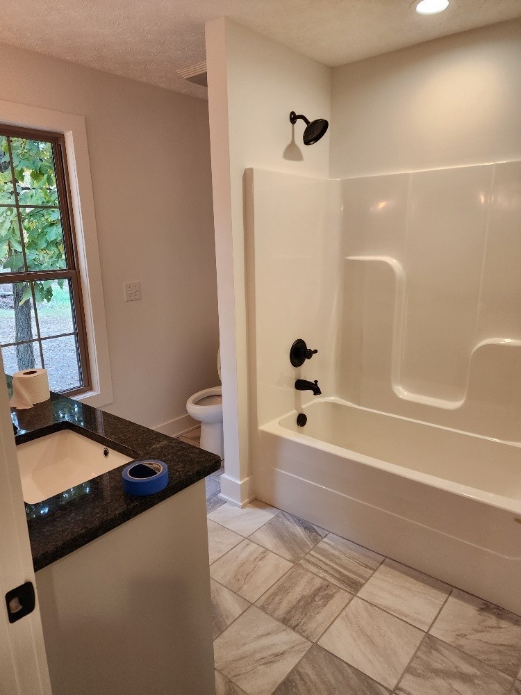 150 Hickory Ridge Lane Hartsville, TN 37074 - Photo 14 of 20 a bathroom with a bathtub and a shower