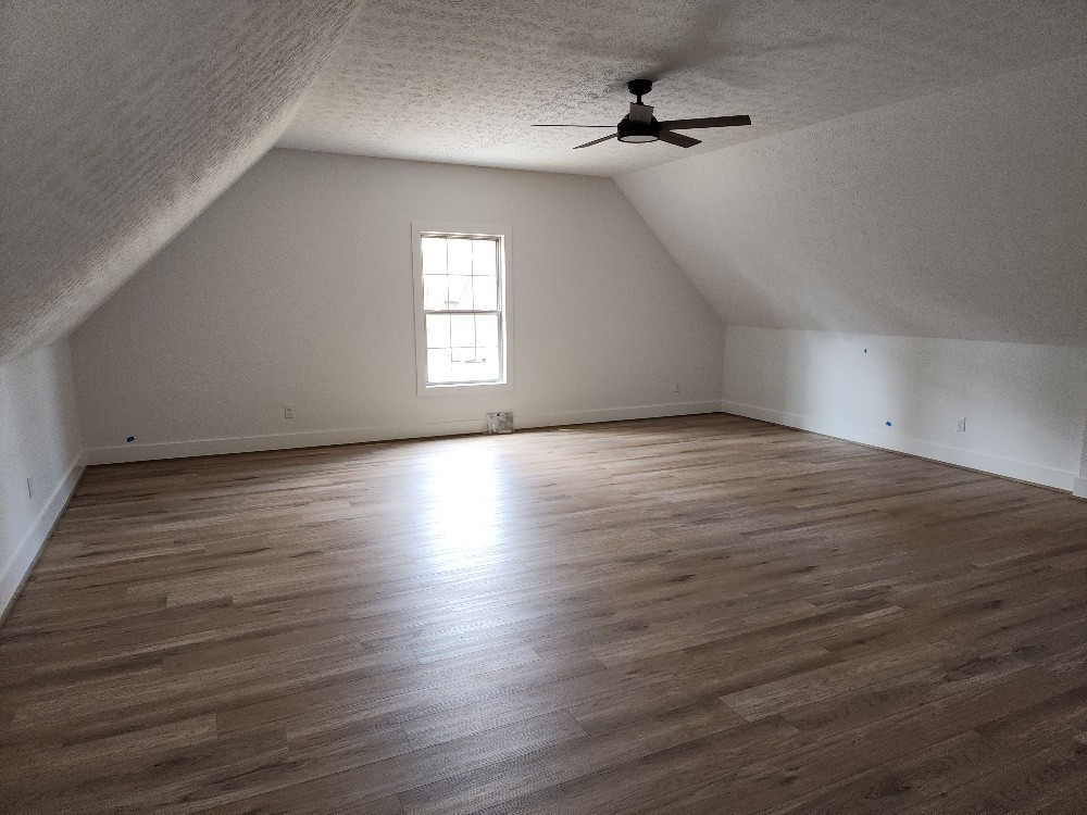 150 Hickory Ridge Lane Hartsville, TN 37074 - Photo 18 of 20 an empty room with wooden floor ceiling fan and windows