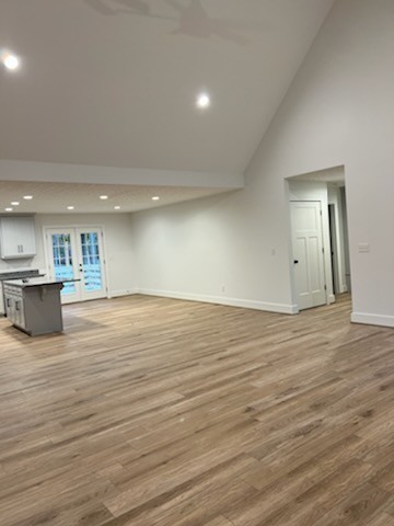 150 Hickory Ridge Lane Hartsville, TN 37074 - Photo 7 of 20 an empty room with wooden floor and kitchen view