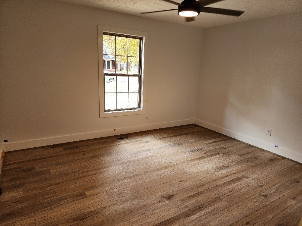 150 Hickory Ridge Lane Hartsville, TN 37074 - Photo 10 of 20 an empty room with wooden floor and windows