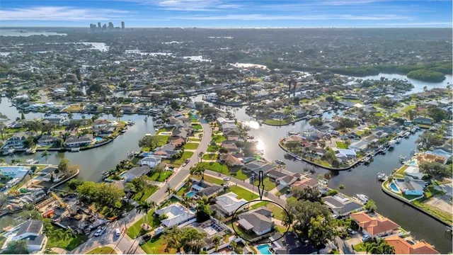 an aerial view of lake and residential houses with outdoor space
