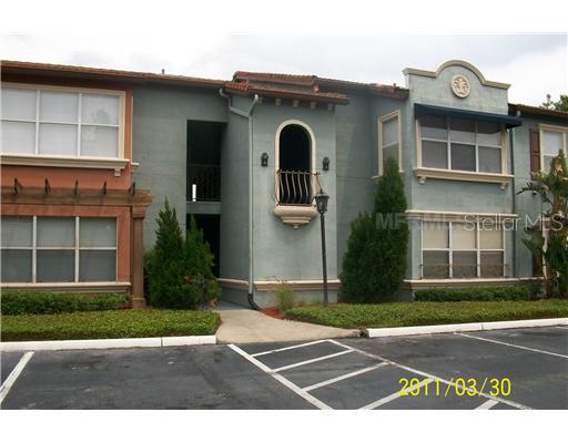 5112 Conroy Road, Unit 16 Orlando, FL 32811 - Photo 1 of 1 a front view of a house with a yard and garage
