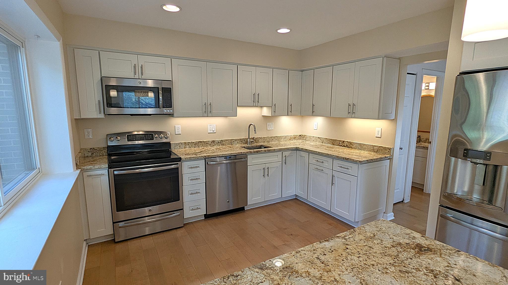 2200 Glencourse Lane Reston, VA 20191 - Photo 11 of 66 a kitchen with a sink stove and refrigerator