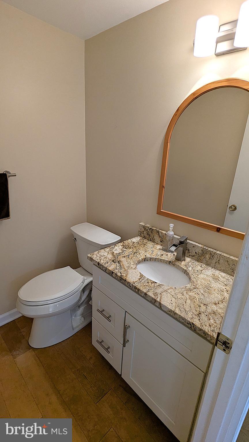 2200 Glencourse Lane Reston, VA 20191 - Photo 14 of 66 a bathroom with a granite countertop toilet and a sink