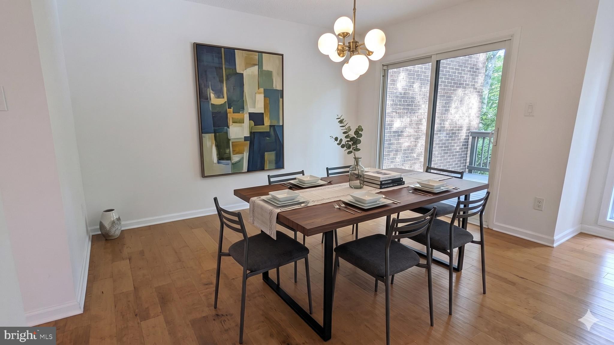 2200 Glencourse Lane Reston, VA 20191 - Photo 18 of 66 a view of a dining room with furniture wooden floor and chandelier