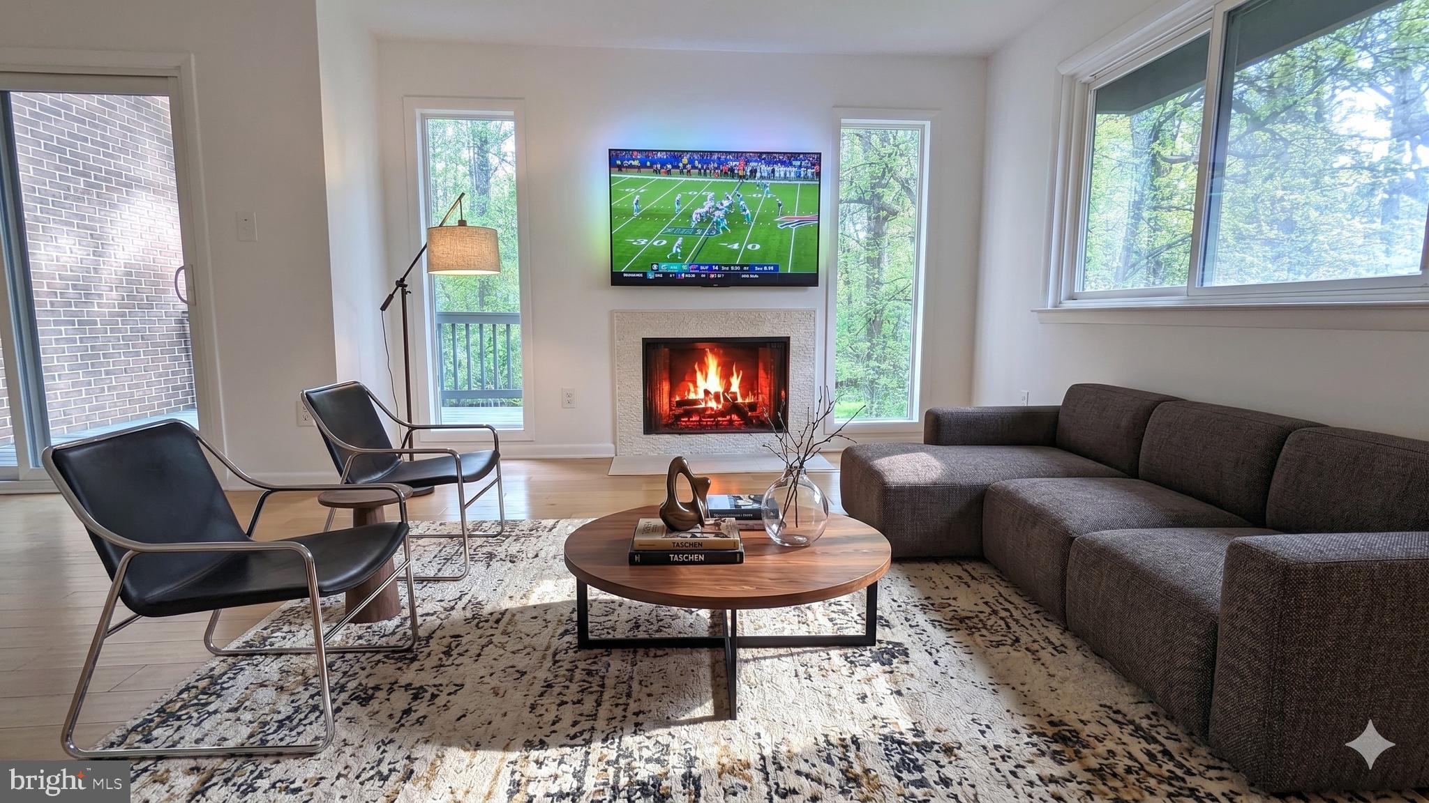 2200 Glencourse Lane Reston, VA 20191 - Photo 25 of 66 a living room with furniture a fireplace and a window
