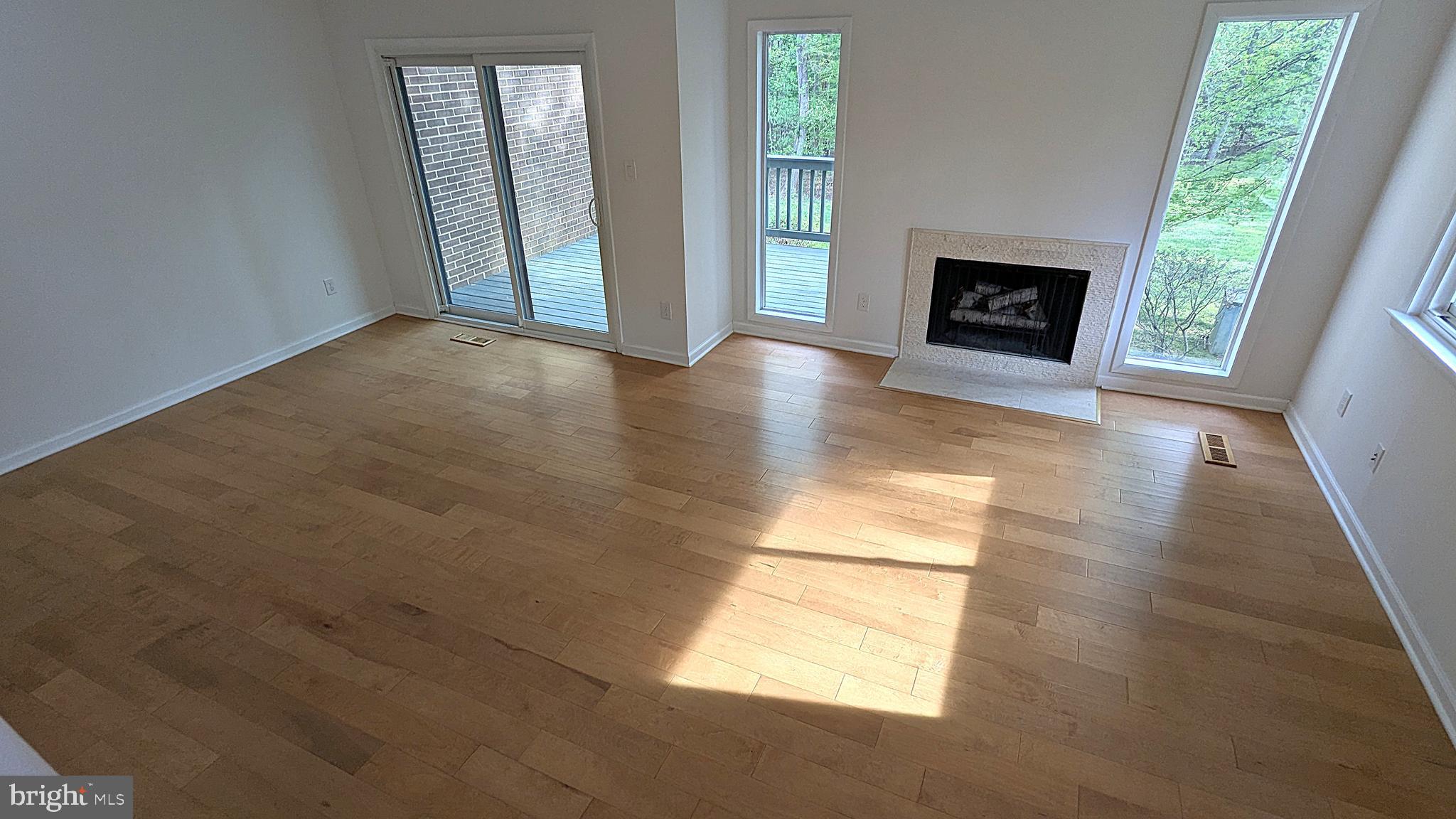 2200 Glencourse Lane Reston, VA 20191 - Photo 26 of 66 an empty room with windows and fireplace