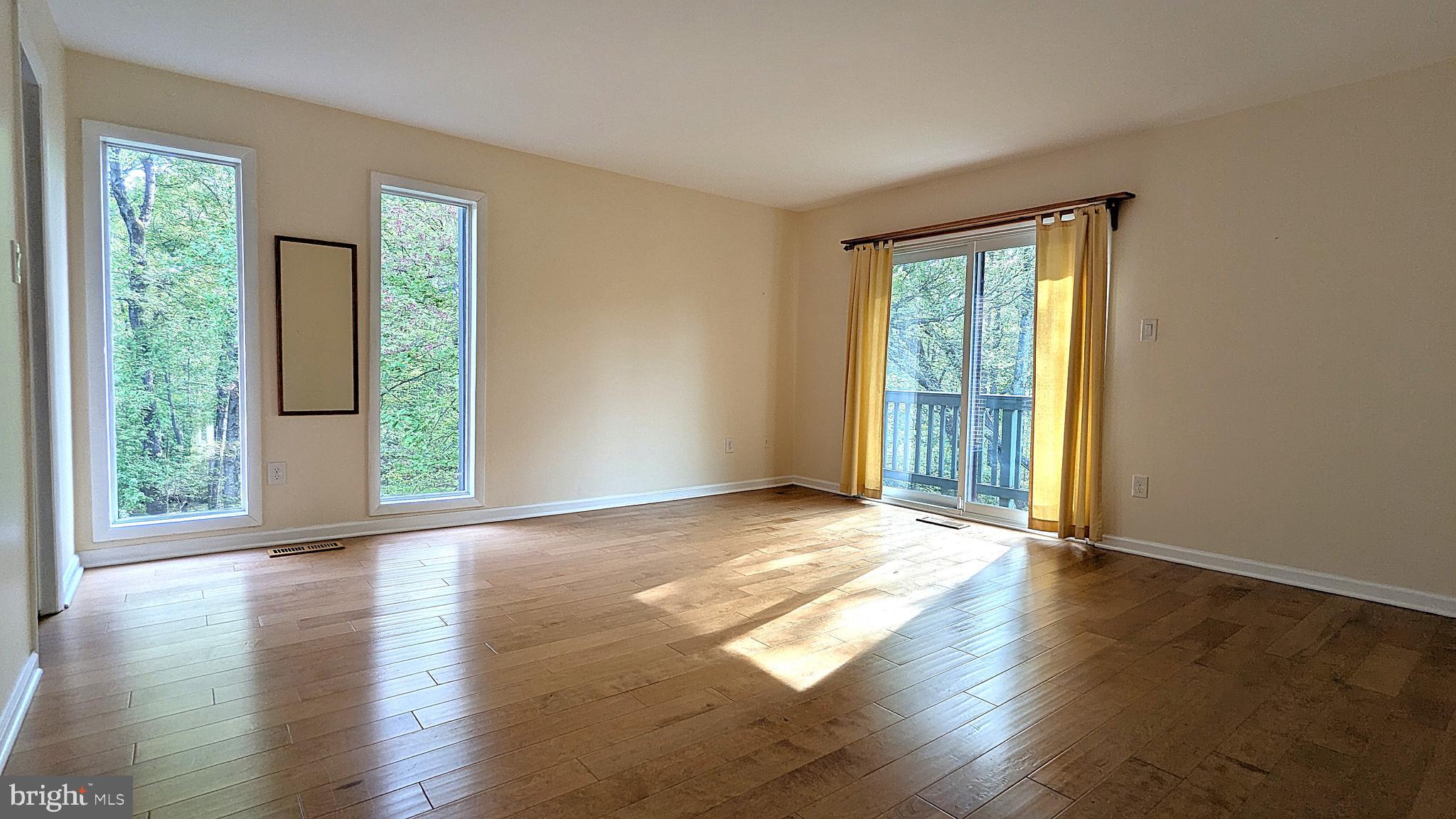 2200 Glencourse Lane Reston, VA 20191 - Photo 28 of 66 a view of an empty room with wooden floor and a window