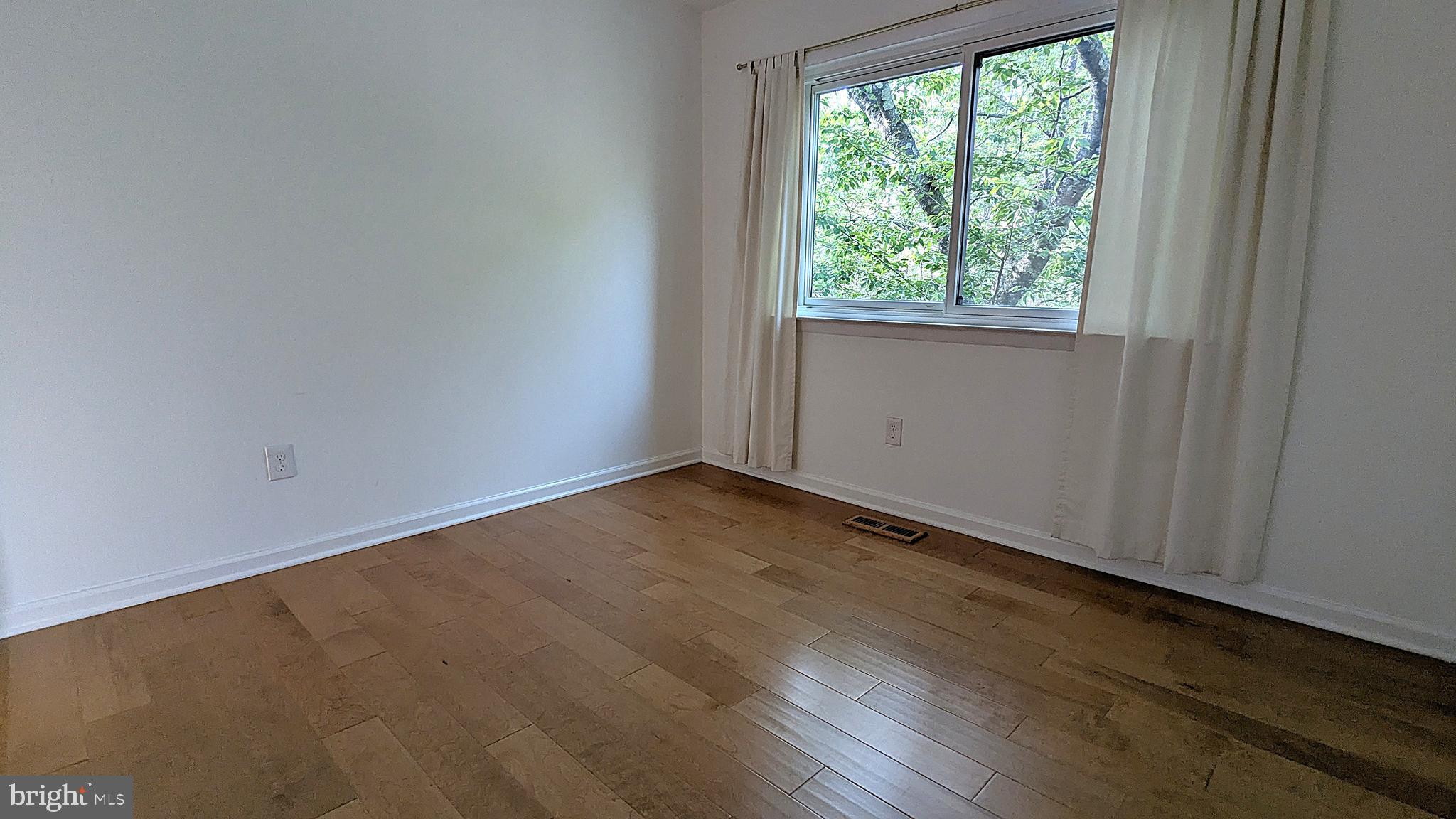 2200 Glencourse Lane Reston, VA 20191 - Photo 38 of 66 an empty room with wooden floor and windows