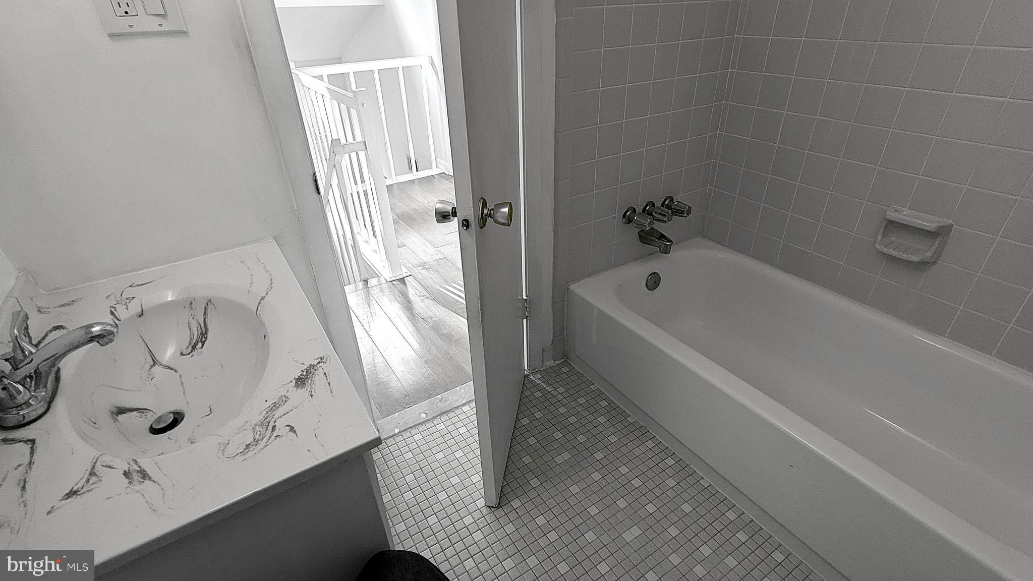 2200 Glencourse Lane Reston, VA 20191 - Photo 40 of 66 a bathroom with a tub a sink and glass door