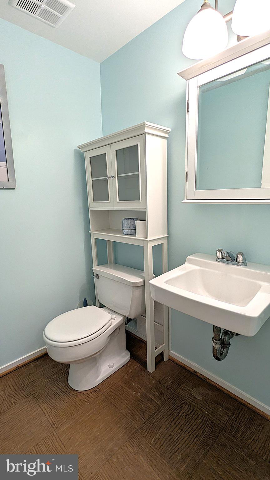 2200 Glencourse Lane Reston, VA 20191 - Photo 56 of 66 a bathroom with a sink a toilet and mirror