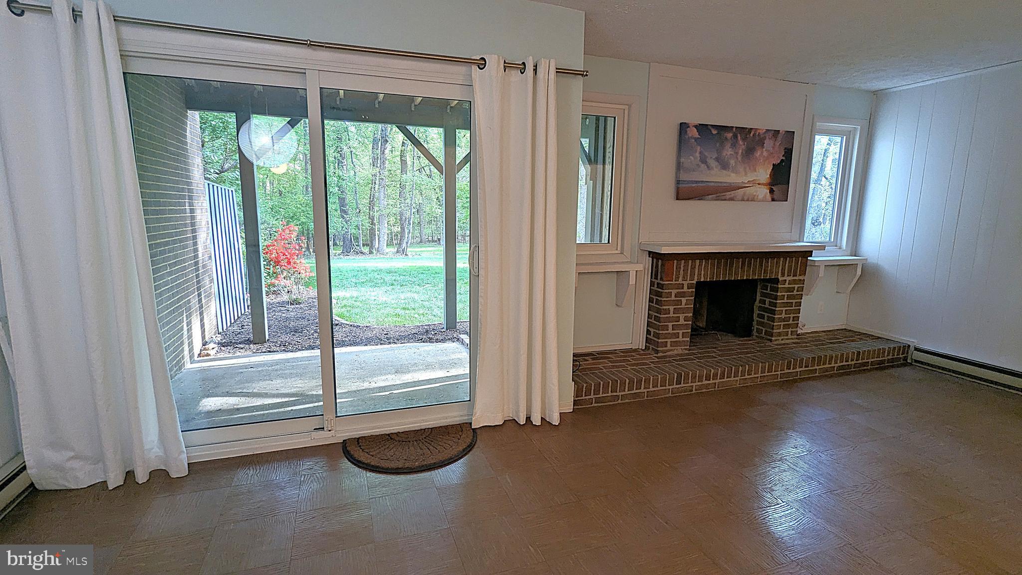 2200 Glencourse Lane Reston, VA 20191 - Photo 57 of 66 a living room with a fireplace and a floor to ceiling window
