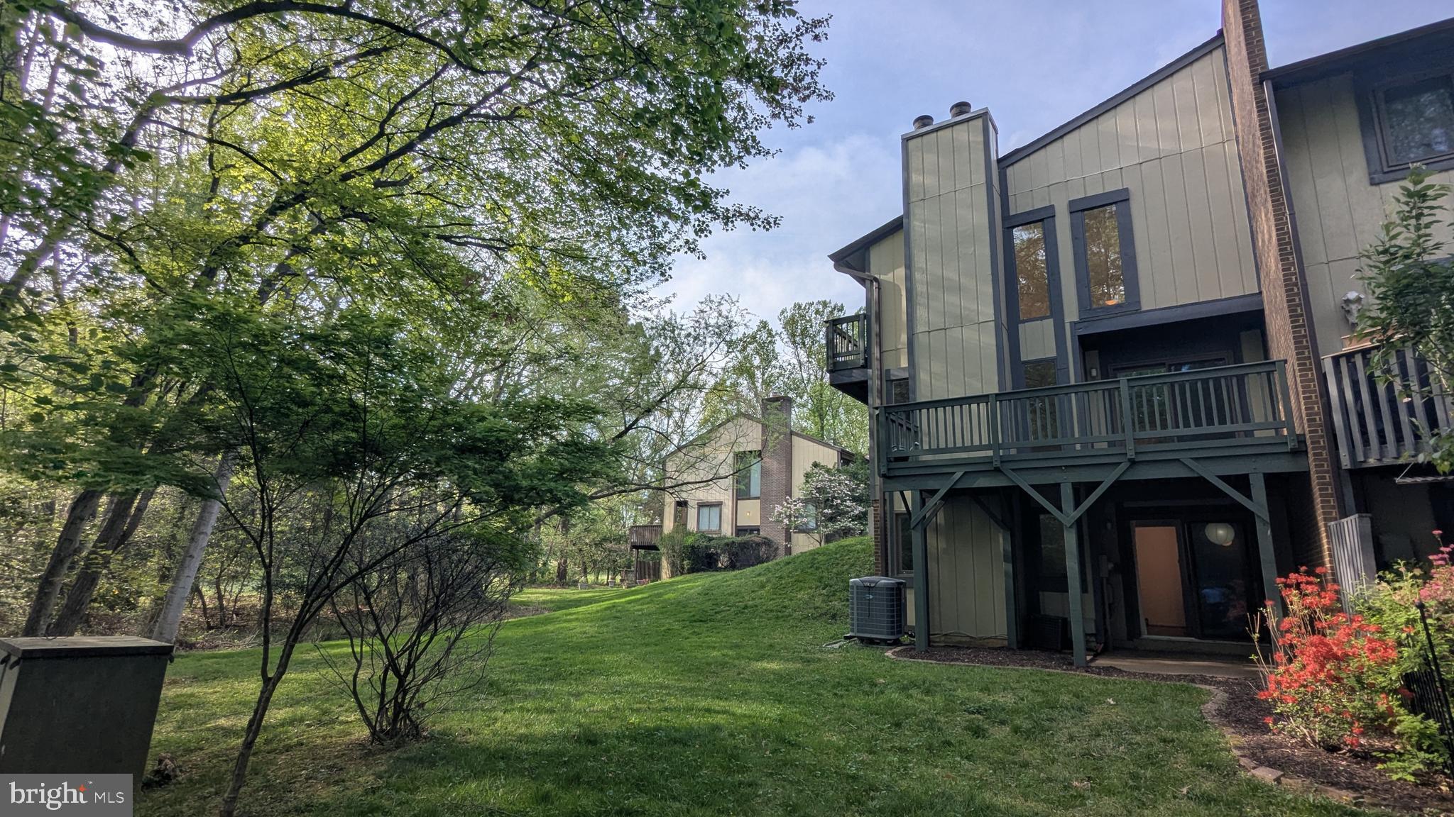 2200 Glencourse Lane Reston, VA 20191 - Photo 64 of 66 a view of house with garden and tall trees