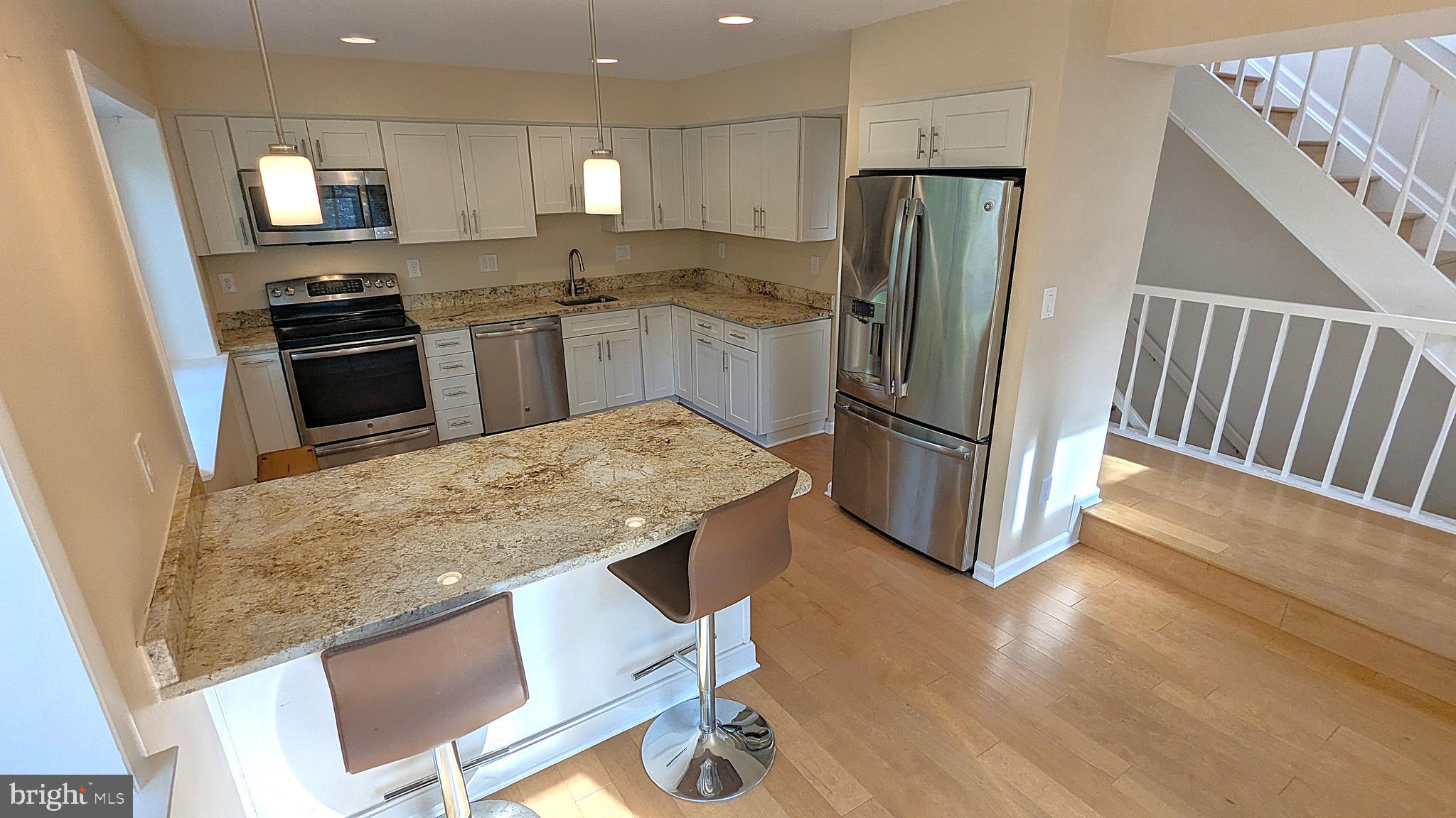 2200 Glencourse Lane Reston, VA 20191 - Photo 10 of 66 a kitchen with stainless steel appliances granite countertop a refrigerator and a stove top oven