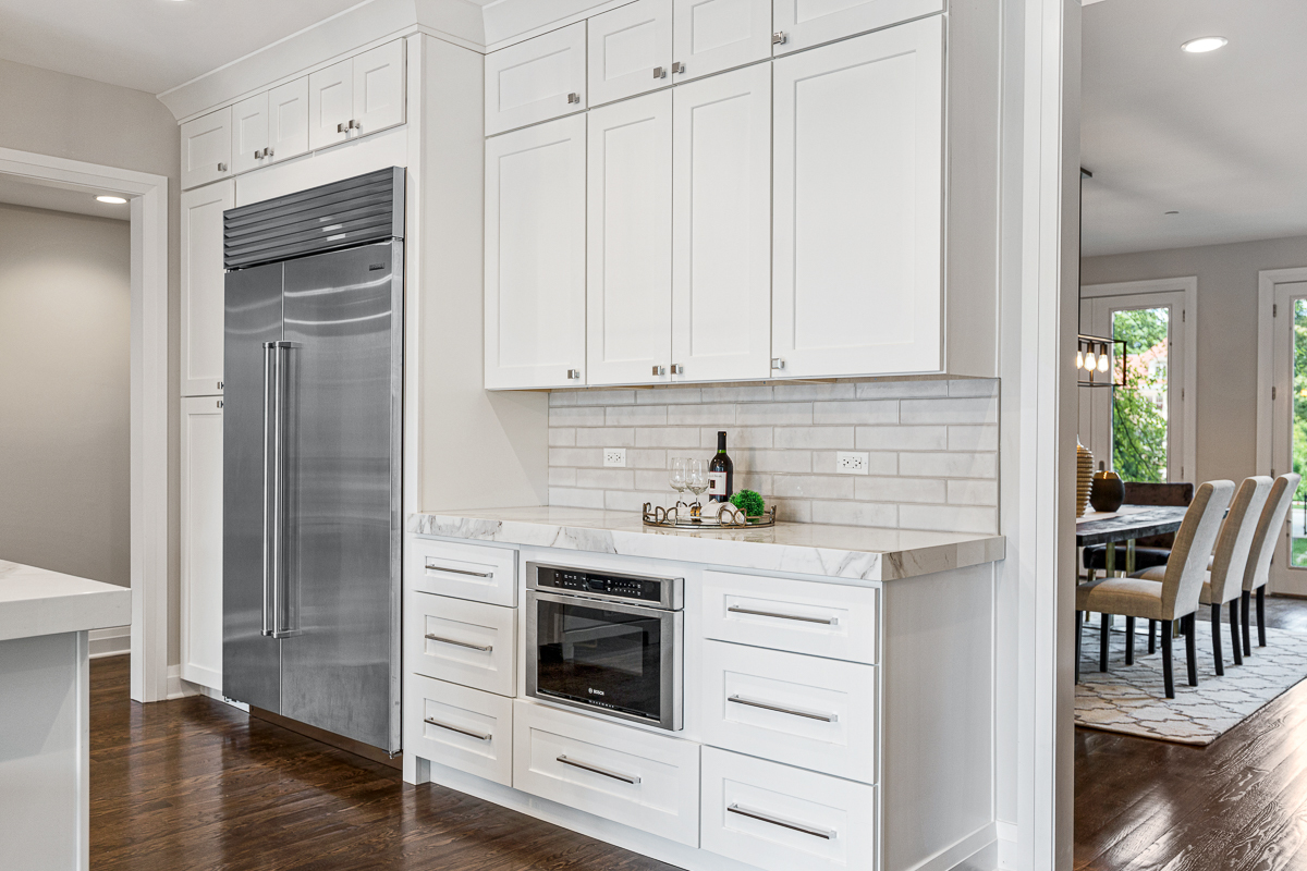 234 Sheridan Road Kenilworth, IL 60043 - Photo 18 of 41 a kitchen with white cabinets and white appliances
