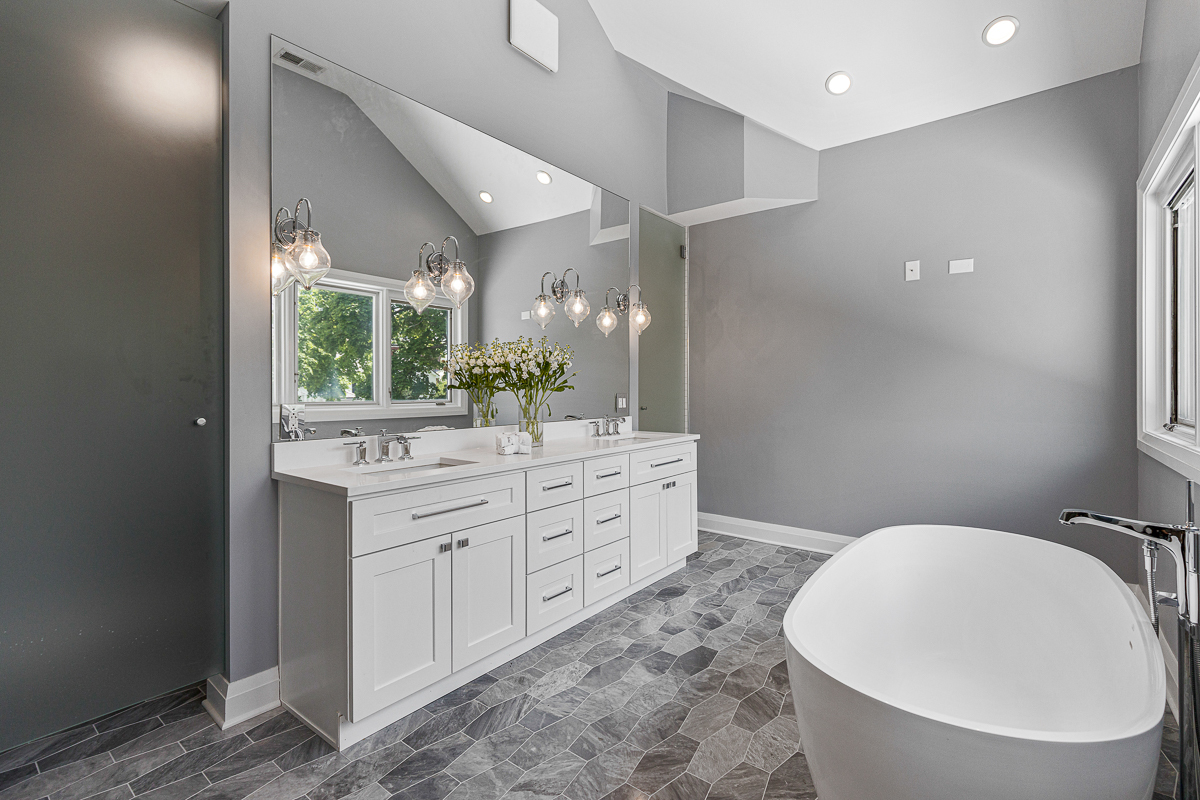 234 Sheridan Road Kenilworth, IL 60043 - Photo 25 of 41 a bathroom with a double vanity sink a toilet and a mirror