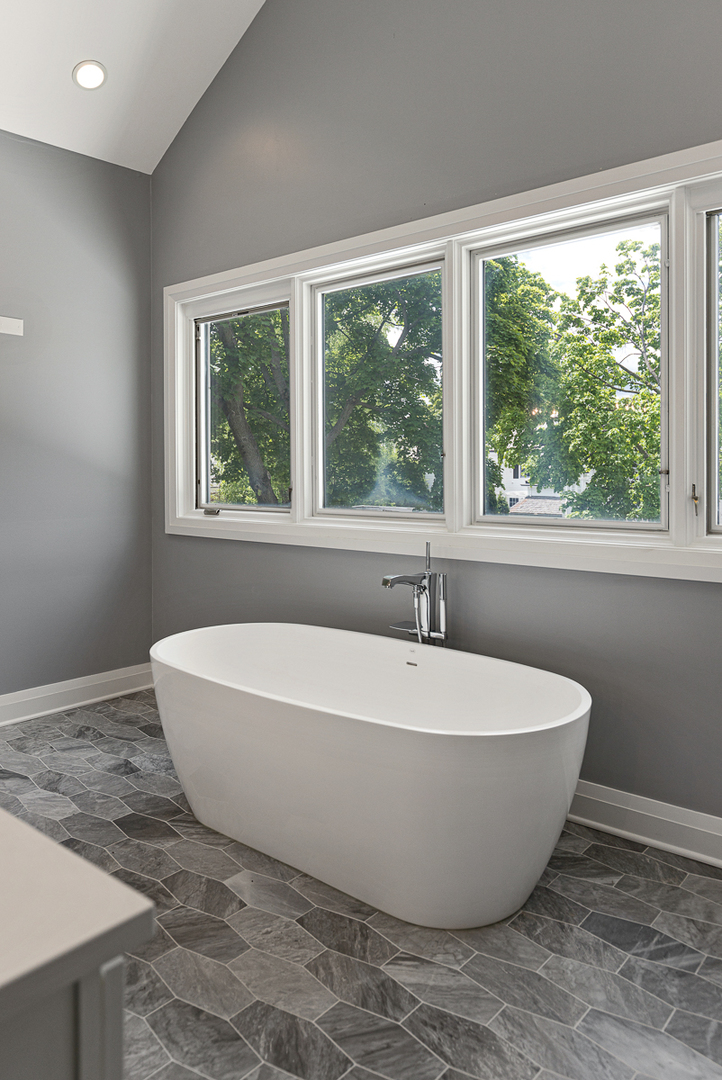 234 Sheridan Road Kenilworth, IL 60043 - Photo 27 of 41 a white tub sitting in a bathroom next to a window