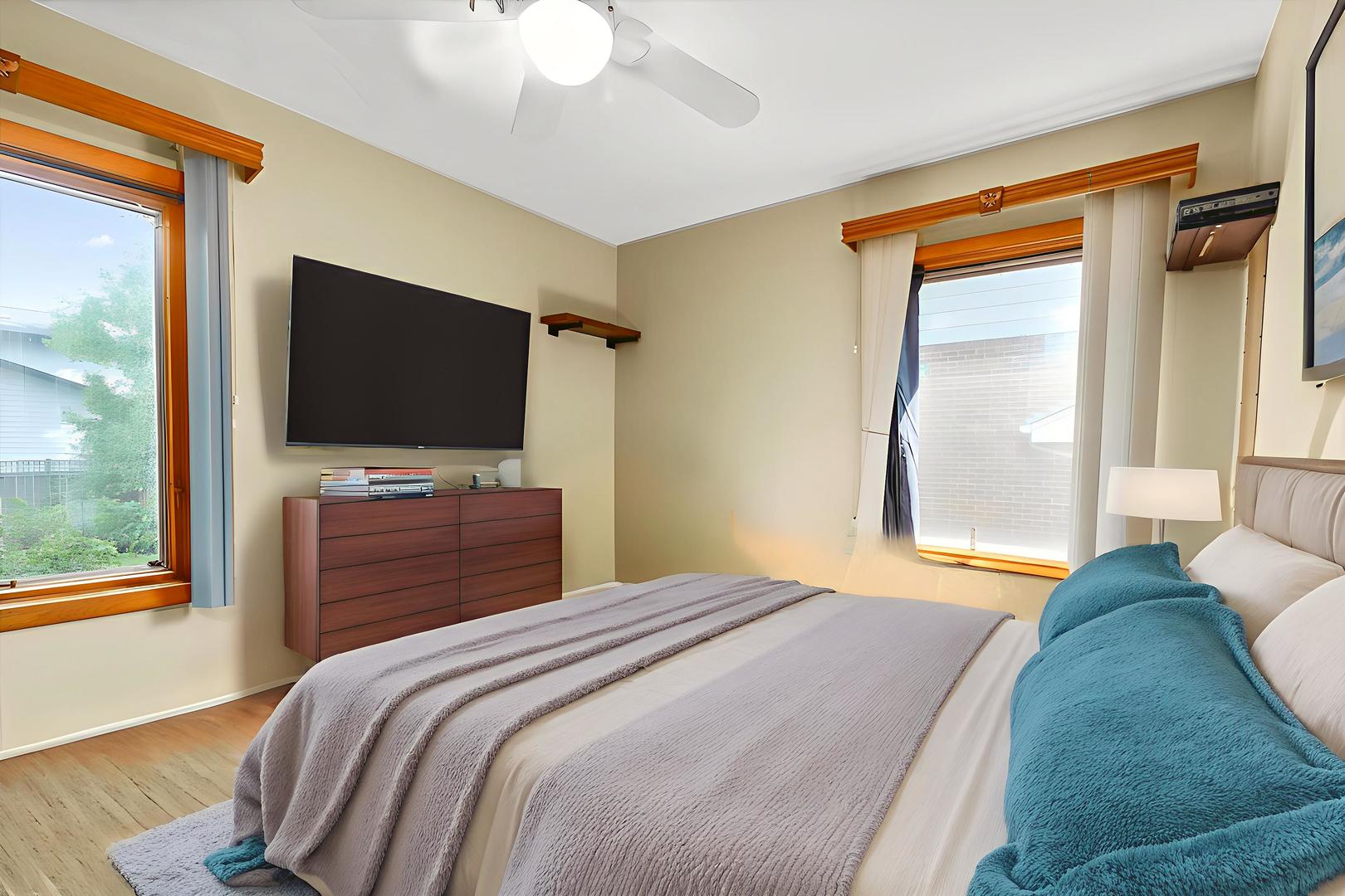 719 North President Street Wheaton, IL 60187 - Photo 7 of 16 a bedroom with a bed and a flat screen tv