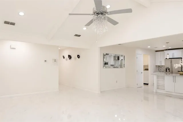 a view of a livingroom with a chandelier fan