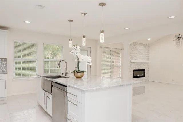 a kitchen with stainless steel appliances granite countertop a sink and a granite counter tops